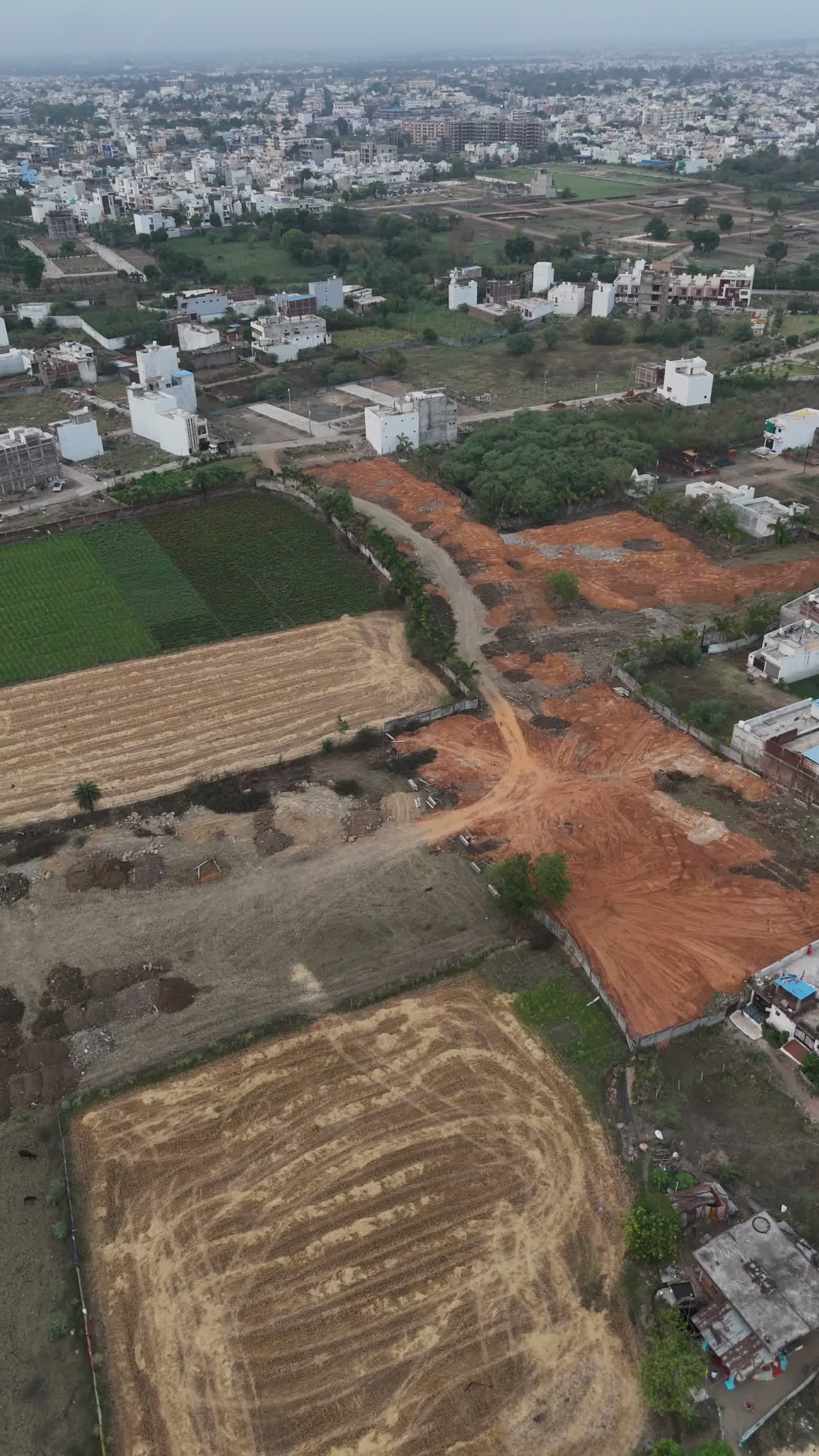 Aerial view of MH Residency plots with greenery and city